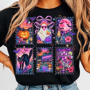 May include: A black t-shirt featuring a graphic print of six rectangular postage stamp-style illustrations. The designs include a jack-o'-lantern, a ghost wearing heart-shaped sunglasses, a full moon, a black cat, a beach scene, and a cocktail.