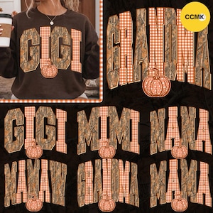 May include: A dark brown sweatshirt featuring the text GIGI in a camouflage and orange gingham pattern with a pumpkin graphic. Additional text options include GRANDMA, MIMI, NANA, and MAMAW, all styled with camouflage, gingham, and pumpkins.