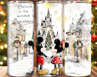 May include: White tumbler featuring Mickey and Minnie Mouse holding hands in front of a castle and a Christmas tree. The tumbler has a winter scene with the text "Believe in the wonder of Christmas".