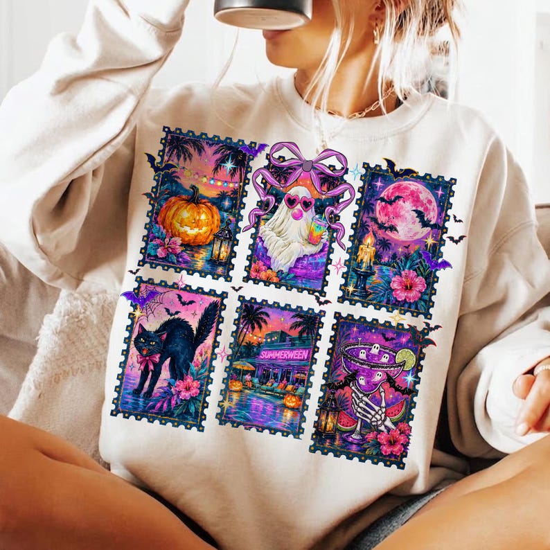 May include: A cream-colored long-sleeve sweatshirt featuring a graphic print of six rectangular postage stamp designs. The illustrations include a pumpkin, a ghost with a pink bow, a full moon, a black cat, a tropical scene, and a skeleton hand holding a drink.