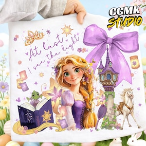 May include: A white decorative pillow featuring a watercolor illustration of a princess with long blonde hair, a purple dress, and the text "At last I see the light." The design includes a castle, a horse, and a large purple bow.