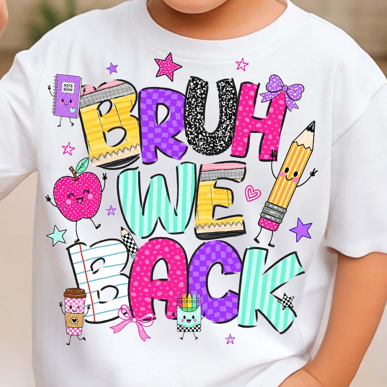 May include: A white t-shirt featuring a colorful graphic with the text BRUH WE BACK. The design includes cartoon school supplies like a notebook, apple, pencil, and coffee cup, decorated with stars, hearts, and bows in pink, yellow, and teal.