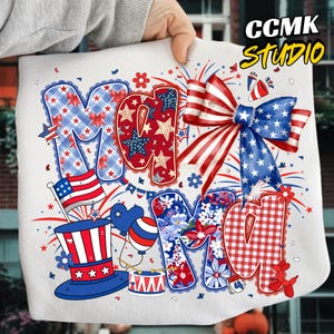 May include: A white graphic featuring the word "Mom" in patriotic red, white, and blue patterns. The design includes stars, bows, flowers, and an American flag, with the text "CCMK STUDIO" in the upper right corner.