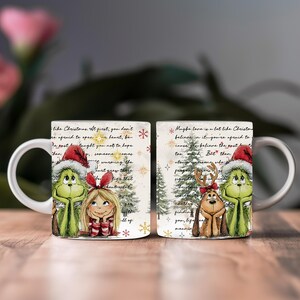 May include: White ceramic mug featuring Grinch and Cindy Lou Who characters in Santa hats, along with a reindeer dog and Christmas trees. The mug has a festive design with snowflakes and text, perfect for holiday gifting.