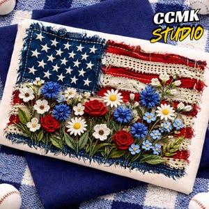 May include: Embroidered American flag design with blue stars, red stripes, and a floral arrangement of red roses, white daisies, and blue flowers. The text "CCMK Studio" is in the upper right corner. The design is on a white background.
