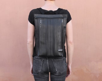 Stylish vegan backpack for woman features waterproof and recycled inner bicycle tube.