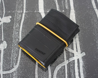 Trifold wallet with yellow elastic band and coin pocket made from recycled inner bike tubes.