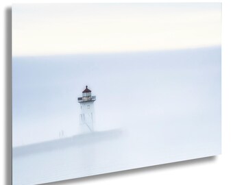 May include: A white lighthouse with a red roof stands on a pier in a foggy, blue-grey sea. The lighthouse is tall and slender, with a small window at the top. The fog is thick and obscures the horizon.