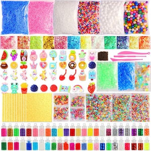 May include: A collection of craft supplies, including bags of colorful foam beads, glitter, and various decorative charms. The charms feature food and animal designs. Small bottles filled with colorful beads are also included.