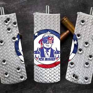May include: Three silver and white insulated beverage holders with a diamond pattern. The center holder features a red, white, and blue American flag with a cartoon image of a man wearing sunglasses and a red, white, and blue hat. The text "You Missed" is printed on the flag.
