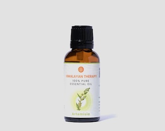 May include: A brown glass bottle with a black cap, labeled "Himalayan Therapy 100% Pure Essential Oil Artemisia".