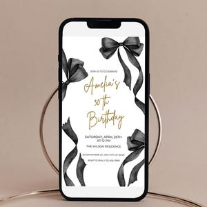 May include: A black and white digital invitation with black ribbon bows and gold text. The text reads "Join us to celebrate Amelia's 30th Birthday. Saturday, April 25th at 12 PM. The Wilson Residence. 123 Anywhere St, Any City, ST 12345. RSVP to Emily 123-456-7890."