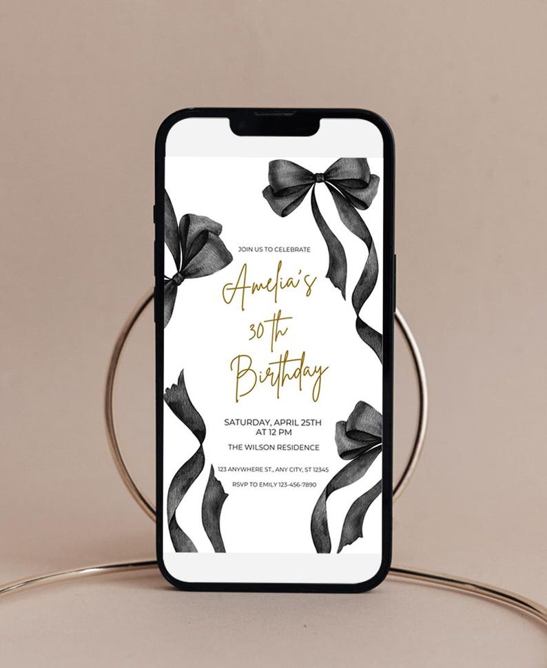 May include: A black and white digital invitation with black ribbon bows and gold text. The text reads "Join us to celebrate Amelia's 30th Birthday. Saturday, April 25th at 12 PM. The Wilson Residence. 123 Anywhere St, Any City, ST 12345. RSVP to Emily 123-456-7890."