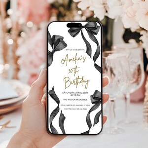 May include: A white and black birthday invitation with gold text. The invitation features a black ribbon with a bow and the text "Join us to celebrate Amelia's 30th Birthday". The invitation also includes the date, time, and location of the event.