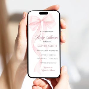 May include: A pink baby shower invitation with a watercolor bow and the text "Please join us for a Baby Shower honoring Sophie Smith. Saturday, June 15th at 12 PM. Smith's Residence 123 Anywhere St. Any City, ST 12345. RSVP to Emily 123-456-7890. Registered at Target & Amazon."