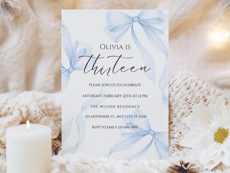 May include: A blue and white invitation card with a watercolor design of blue bows. The text on the card reads "Olivia is Thirteen. Please join us to celebrate Saturday, February 22th at 12 PM. The Wilson Residence 123 Anywhere St., Any City, ST 12345 RSVP to Emily 123-456-7890"