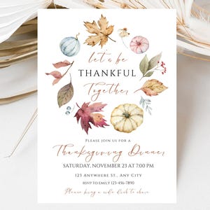 May include: Thanksgiving dinner invitation with watercolor illustrations of pumpkins, leaves, and berries. The text reads "Let's be thankful together" and includes event details such as date, time, and location.