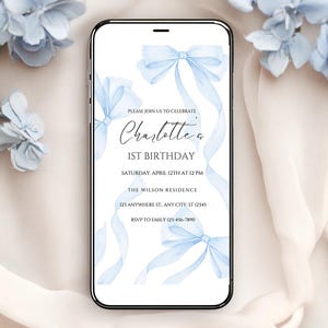 May include: A blue and white digital invitation for a 1st birthday party. The invitation features a watercolour illustration of blue ribbons and bows. The text on the invitation reads "Please join us to celebrate Charlotte's 1st Birthday. Saturday, April 12th at 12 PM. The Wilson Residence. 123 Anywhere St, Any City, ST 12345. RSVP to Emily 123-456-7890."