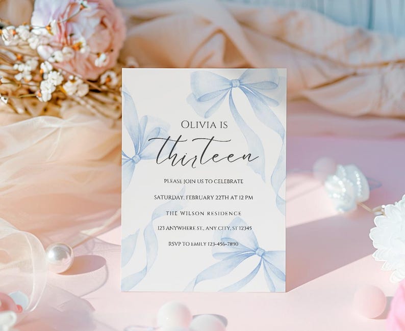 May include: A blue and white invitation card with a watercolor design of bows. The text on the card reads "Olivia is Thirteen" and includes details for a birthday party.