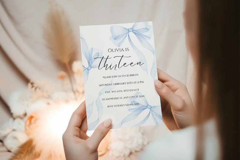 May include: A blue and white invitation card with watercolor blue bows and the text "Olivia is thirteen" and details for a birthday party.