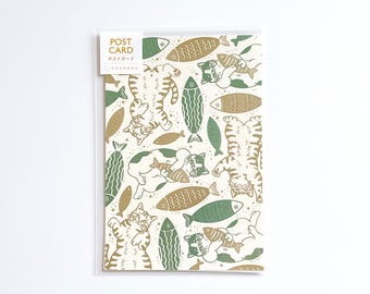 May include: A postcard with a repeating pattern of cats and fish in green and brown on an off-white background. The postcard is labelled "Post Card" in English and Japanese. The cats are depicted in various playful poses.