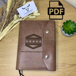 May include: A white ceramic mug with a black handle and the text "But First, Coffee" in a bold, black font. The mug is set against a blurred background, suggesting a cosy setting.