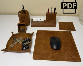Könnte beinhalten: Ein Schreibtisch-Set aus braunem Leder mit Stiftehalter, Visitenkartenhalter, quadratischer Ablageschale mit Münzen und USB-Sticks, quadratischem Untersetzer und Mauspad mit schwarzer Computermaus. Jedes Teil zeigt ein Stier-Logo und S.I.L.C.