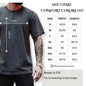 May include: A dark gray Comfort Colors 1717 t-shirt with a size chart. The chart lists sizes S to 4XL, with widths from 18.25 to 29.75 inches and lengths from 26.6 to 33.5 inches. The model is 5'8" and wearing a size large.