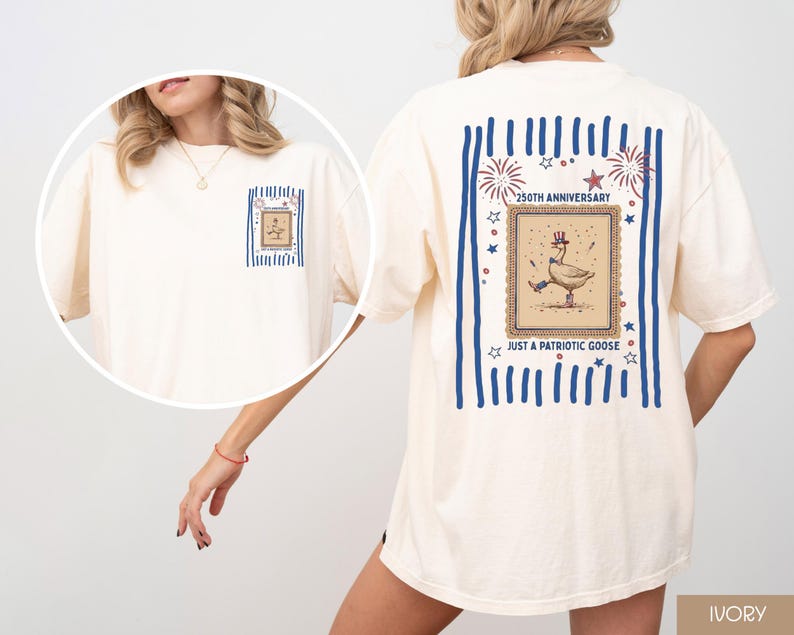 May include: Ivory t-shirt with a patriotic goose design. The graphic shows a goose in a hat, dancing, with text reading "250th Anniversary" and "Just a Patriotic Goose". The back of the shirt has blue stripes and stars, with a framed design.