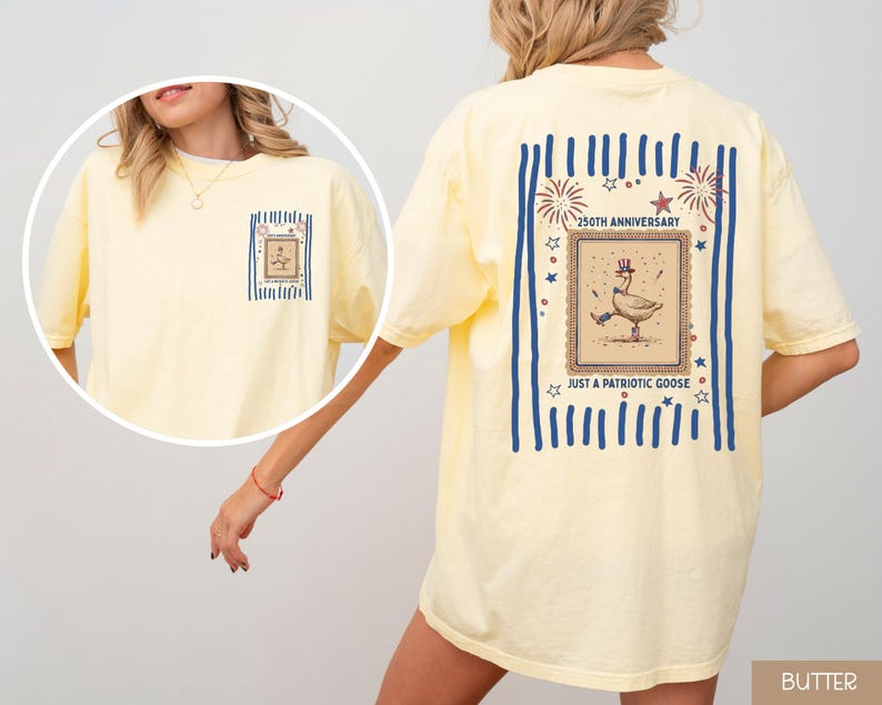 May include: Pale yellow t-shirt with a patriotic goose design. The back displays a framed illustration of a goose in a top hat, with the text "250th Anniversary" and "Just a Patriotic Goose". The front has a smaller version of the graphic.