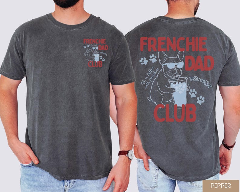 May include: Pepper-colored t-shirt with "FRENCHIE DAD CLUB" in red text. The front features a small graphic of a French Bulldog with sunglasses. The back displays a larger graphic of the dog with a drink and paw prints.