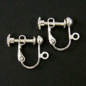 May include: Two silver clip-on earring backs. Each back has a screw-on post and a small ball at the end.