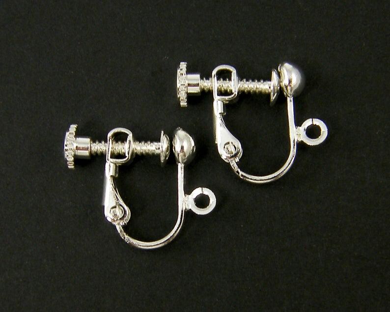 May include: Two silver clip-on earring backs. Each back has a screw-on post and a small ball at the end.