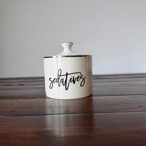 May include: A rustic wooden sign with the text "Welcome to our home" in white lettering. The sign features a distressed finish and a simple, inviting design, perfect for a front porch or entryway.