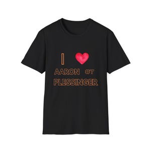 May include: Black t-shirt with the text "I ♥ Aaron #7 Plessinger" in orange and a red heart graphic. The shirt is a crew neck style.