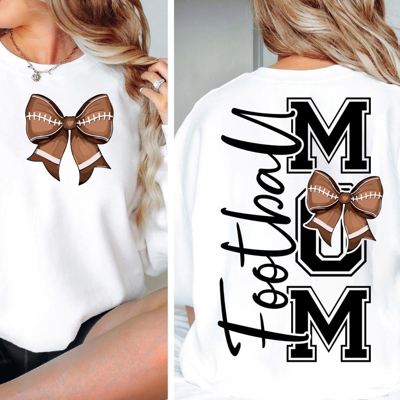 May include: White sweatshirt featuring a football-shaped bow on the front and the words "Football Mom" on the back. The bow is brown with white stitching, and the text is in black.
