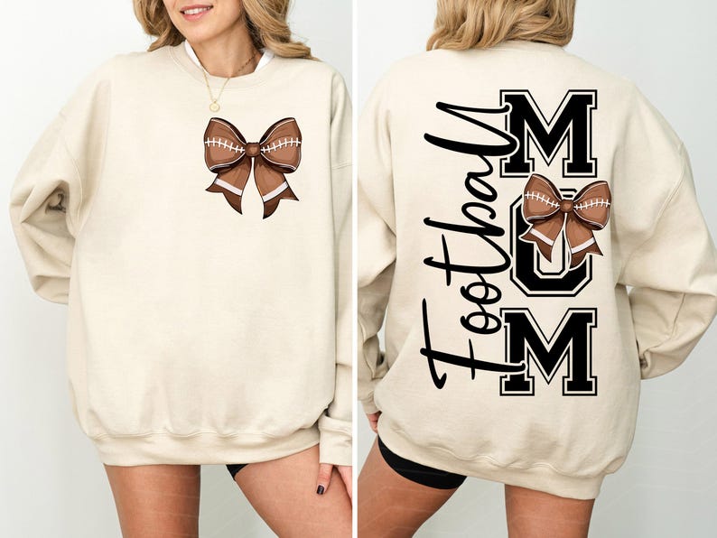 May include: A cream-colored sweatshirt featuring a football-shaped bow design on the front. The back of the sweatshirt displays the words "Football Mom" in black script and block letters, with a football bow graphic.