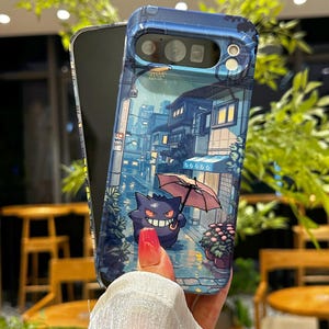 May include: A clear phone case featuring a colorful illustration of a purple cartoon character holding an umbrella in a rainy street scene. The case has a blue border and is wrapped around a black phone.