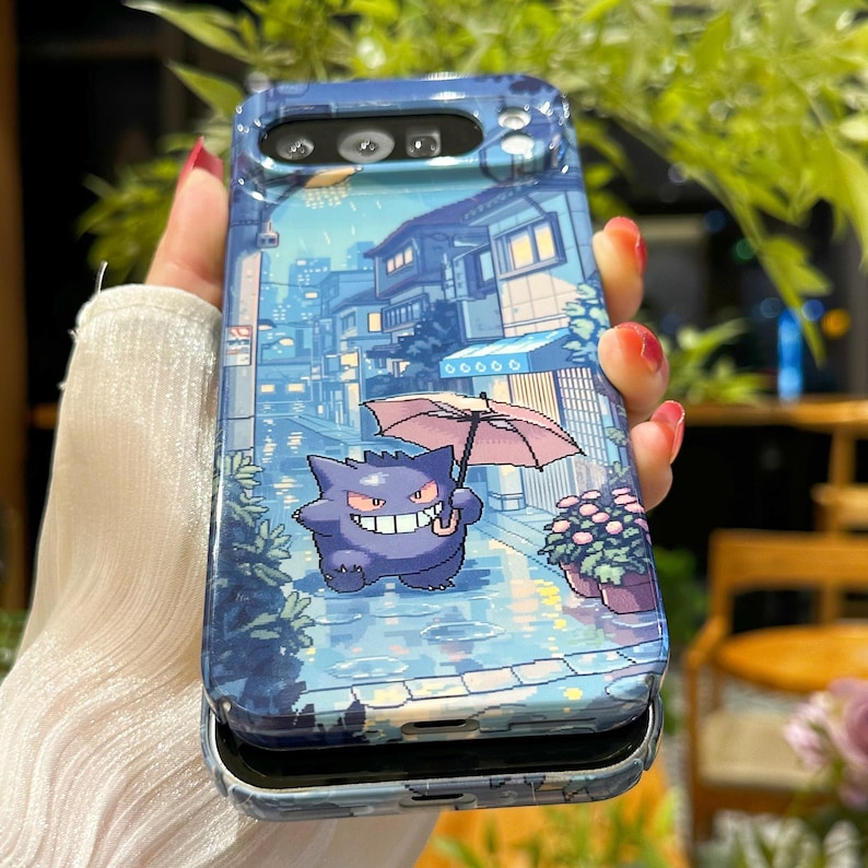 May include: A blue phone case featuring a pixelated illustration of a purple cartoon character holding an umbrella in a rainy street scene. The case has a protective design and a camera cutout.