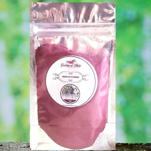 May include: A small resealable pouch filled with a deep red hibiscus powder. The pouch has a label that reads "Goddess of Herbs" and "Hibiscus Powder".