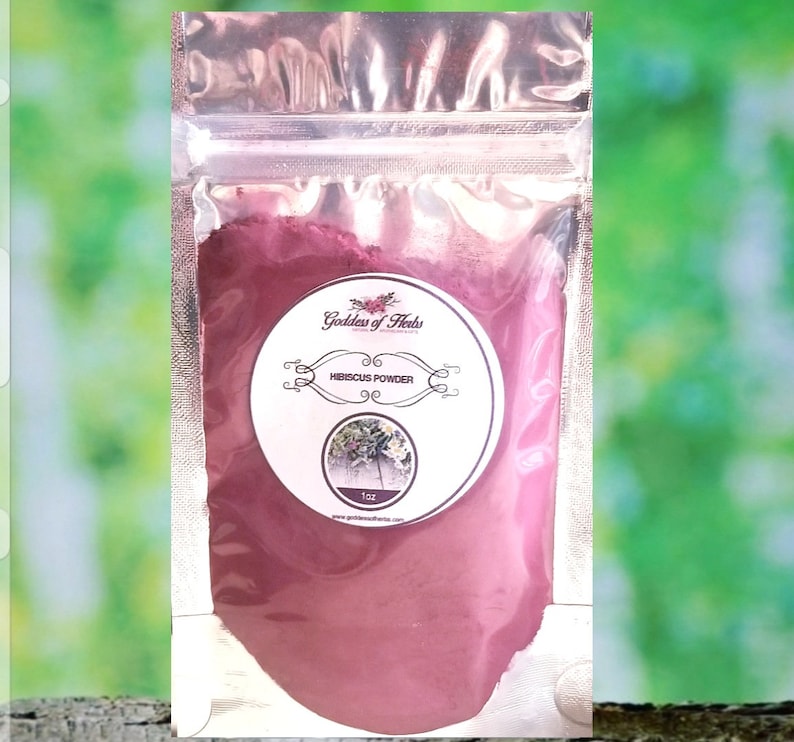 May include: A small resealable pouch filled with a deep red hibiscus powder. The pouch has a label that reads "Goddess of Herbs" and "Hibiscus Powder".