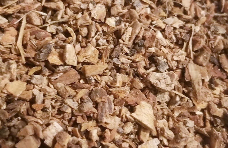 May include: Close-up of a pile of dried, chopped bark pieces. The bark fragments vary in size and shape, with a mix of light brown, tan, and darker brown hues. Some pieces have a rough, textured surface, while others appear smoother. The image suggests a natural, organic material.
