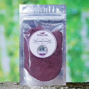 May include: A small resealable pouch containing a purple acai berry powder. The pouch has a label that reads "Goddess of Herbs" and "Acai Berry Powder" with a small image of acai berries. The label also states "1 oz".