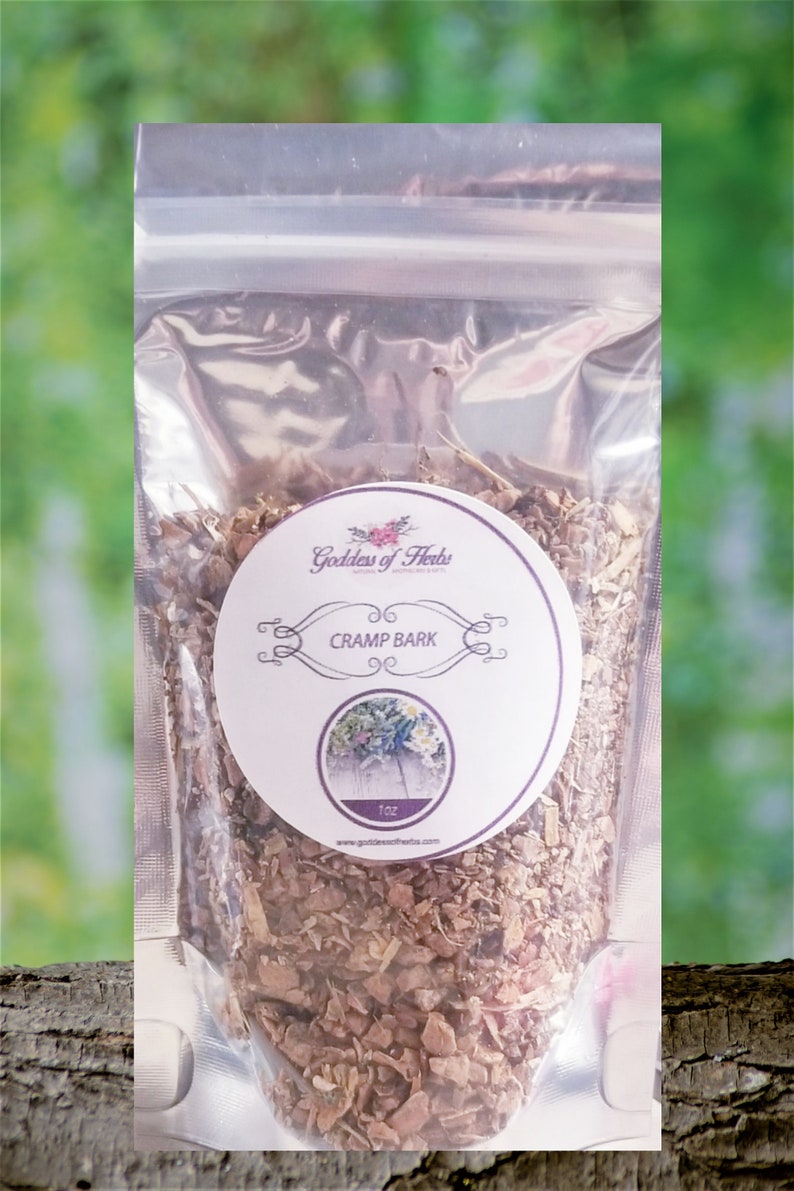May include: A clear plastic bag filled with brown, dried herbs. A white circular label features the text "Cramp Bark" and a floral illustration. The bag is labeled "1oz" and the brand name "Goddess of Herbs" is visible.