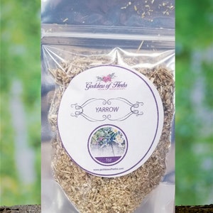May include: A clear plastic bag containing 1 oz of dried Yarrow herb. The bag has a white label with the text "Goddess of Herbs" and "Yarrow" in purple lettering. The label also features a small image of a Yarrow plant.