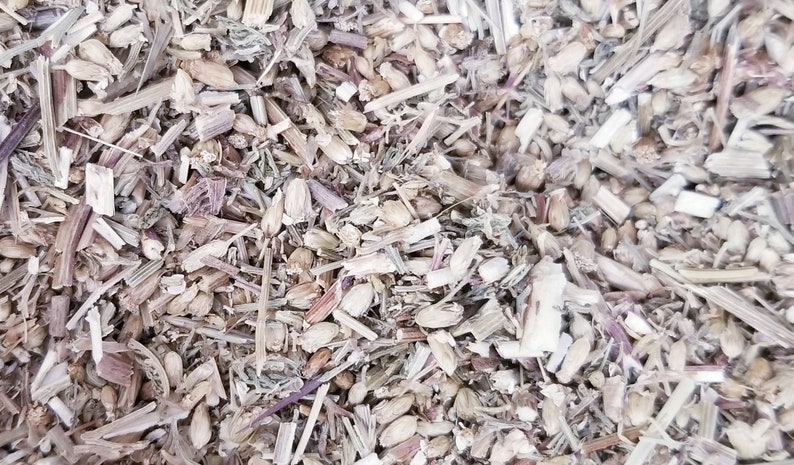 May include: Close-up of a mixture of dried herbs and seeds, including brown stems, light brown seeds, and small green leaves.