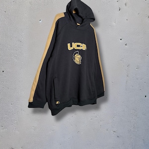 May include: Black hooded sweatshirt with gold sleeve stripes. The front displays "UCE" in gold, above a gold helmet crest. The Starter logo is visible on the lower left.