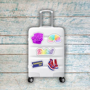 May include: A white suitcase adorned with colorful stickers. Stickers include a purple armchair, a rainbow slinky, the word "Radical" in script, a Blockbuster Video logo, and a pair of Union Jack sneakers.