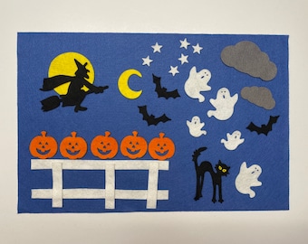 Puede incluir: Una escena de Halloween de fieltro con una bruja volando en una escoba, un gato negro, calabazas, fantasmas y estrellas sobre un fondo azul.