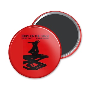 May include: Red round magnet with a black silhouette of a person standing on a stage lift. The text "HOPE ON THE STAGE" is printed in black on the magnet. The text "J-HOPE TOUR" and "NORTH AMERICA" are printed in smaller black text below the main text.